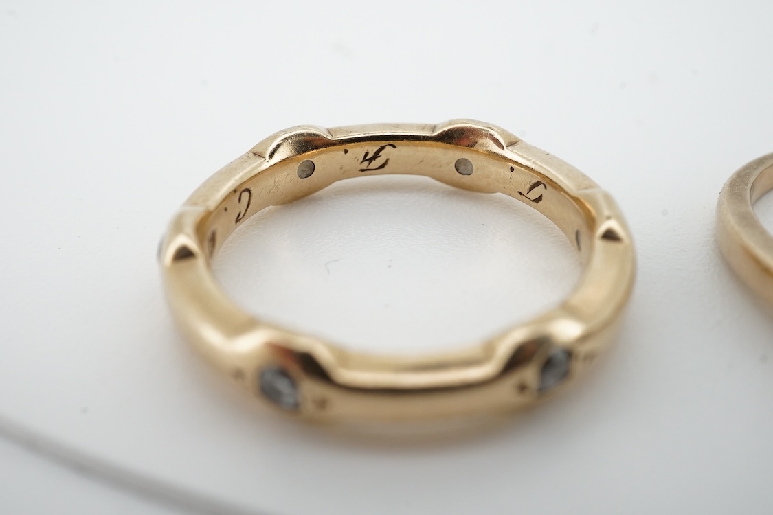 A modern 9ct gold and claw set single stone diamond ring, with four stone diamond chip set shoulders, size N, total carat weight approximately 0.20ct and a similar 9ct gold and six stone diamond set band, size K, gross w